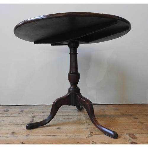 72 - A GEORGE III MAHOGANY TILT-TOP TRIPOD TABLE, the single piece top raised on a turned baluster pedest... 