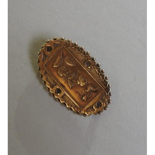 378 - A 19TH CENTURY 9CT GOLD OVAL BROOCH, the central oblong panel with floral decoration, with a beaded ... 