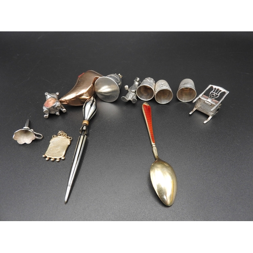 334 - THREE SILVER THIMBLES, THREE NOVELTY PIN CUSHIONS AND A SILVER TOOTH FLASK, along with charms, trink... 