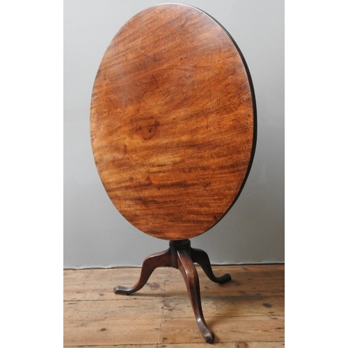 77 - A GEORGE III MAHOGANY TILT TOP TRIPOD TABLE, the circular single piece top sat atop a turned baluste... 