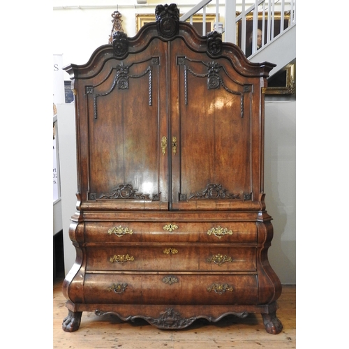 79 - A DUTCH EARLY 19TH CENTURY MAHOGANY LINEN PRESS, the arch stepped cornice sat over two arch molded d... 