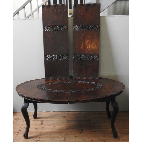 81 - AN UNUSUAL CARVED KASHMIRI WALNUT DINING TABLE, the oval top carved in the form of a lily pad, with ... 