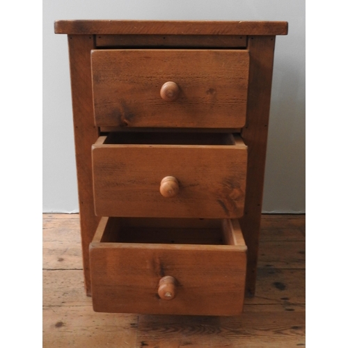 83 - A 20TH CENTURY PINE BEDSIDE CHEST, of simplistic form, consisting of three drawers with turned woode... 