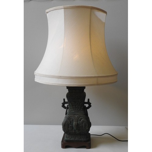 112 - A CHINESE STYLE CAST METAL TABLE LAMP, the base 44 x 21 x 17 cm (90cm high inc shade)