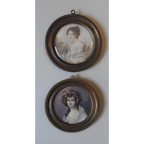 390 - A PAIR OF EARLY 19TH CENTURY PORTRAIT WATER COLOURS OF REGENCY LADIES, in circular frames, 5.5 cm di... 