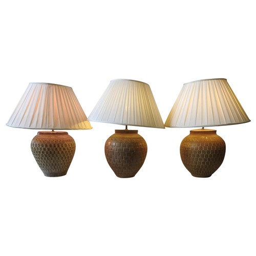 114 - THREE LARGE CONTEMPORARY TABLE LAMPS, of baluster form, with varying mosaic style relief patterns