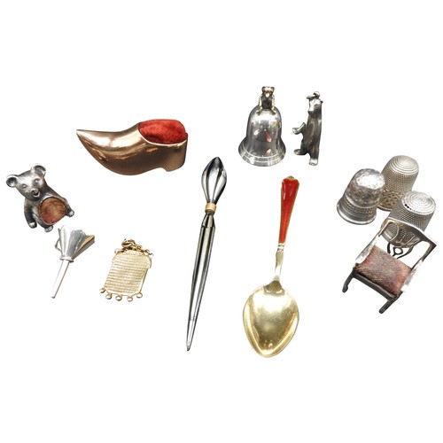 334 - THREE SILVER THIMBLES, THREE NOVELTY PIN CUSHIONS AND A SILVER TOOTH FLASK, along with charms, trink... 