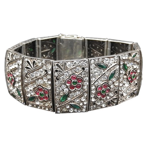 369 - A SILVER AND PASTE BRACELET, circa 192012 panels each set with white pink and green paste in a flora... 