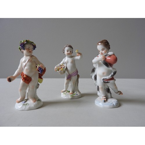 402 - THREE 19TH CENTURY MEISSEN PUTTO FIGURINES,  Bacchus style figure, putto with flower basket and putt... 