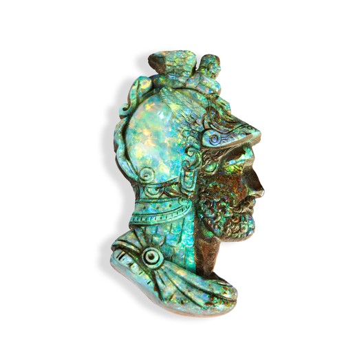 WILHELM SCHMIDT; A CARVED OPAL, CIRCA 1880 the carved opal depicting the head of a warrior, his helmet surmounted by The Sphinx, the reverse host stone also carved.