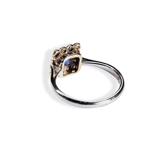 119 - A SAPPHIRE & DIAMOND PLAQUE RING CIRCA 1900.the millegrain square cut sapphire surrounded by twe... 