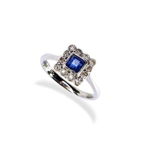 119 - A SAPPHIRE & DIAMOND PLAQUE RING CIRCA 1900.the millegrain square cut sapphire surrounded by twe... 