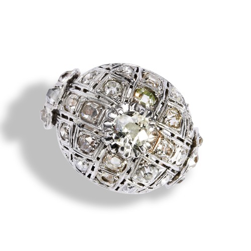 114 - A DIAMOND BOMBE DRESS RING a central round cut diamond set above a dome set with eighteen old cut di... 