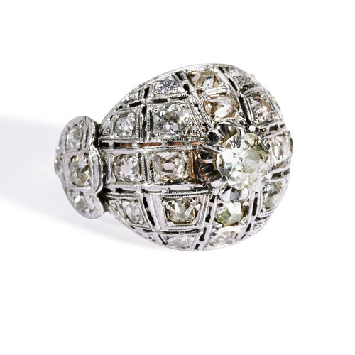 114 - A DIAMOND BOMBE DRESS RING a central round cut diamond set above a dome set with eighteen old cut di... 