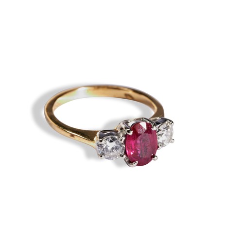 116 - A RUBY AND DIAMOND THREE STONE RING the central oval mixed-cut ruby between two round cut diamonds o... 