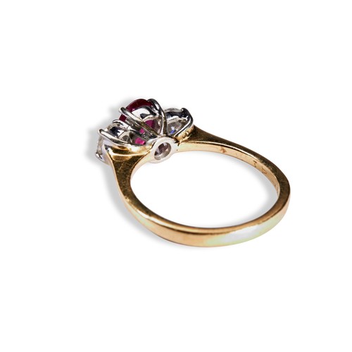 116 - A RUBY AND DIAMOND THREE STONE RING the central oval mixed-cut ruby between two round cut diamonds o... 