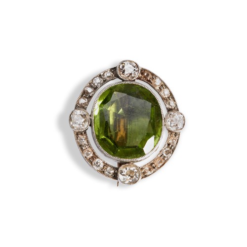 148 - A NINETEENTH CENTURY PERIDOT AND DIAMOND BROOCH, CIRCA 1900,  the oval mixed-cut peridot within a ha... 