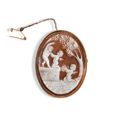 127 - A VICTORIAN SHELL CAMEO BROOCH, CIRCA 1890, the oval shall cameo carved to depict frolicking putti, ... 