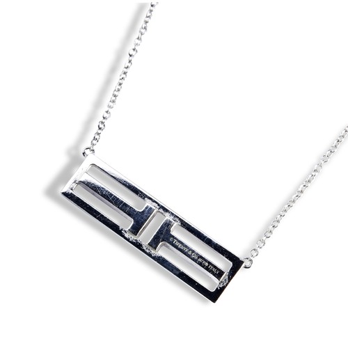 70 - A TIFFANY DIAMOND BAR NECKLACEThe two diamond set letter T's are horizontally set within a plain obl... 