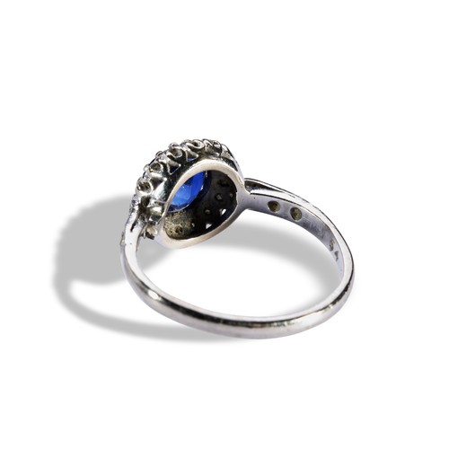 140 - A SAPPHIRE AND DIAMOND CLUSTER RINGthe circular mixed cut, within a bezel of sixteen eight-cut diamo... 