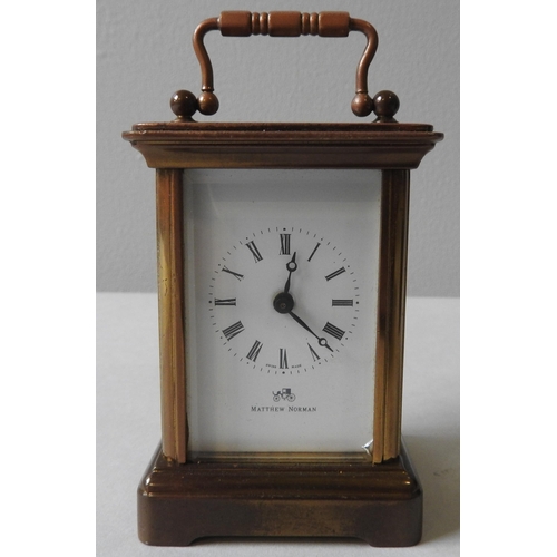 174 - A SWISS MADE BRASS CASED MINIATURE CARRIAGE CLOCK, eleven jewels, the face inscribed 'Matthew Norman... 