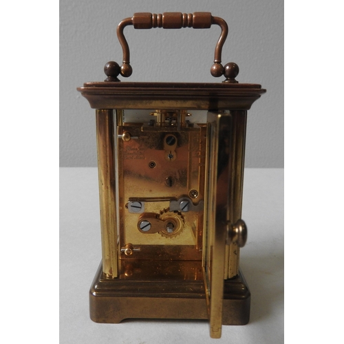 174 - A SWISS MADE BRASS CASED MINIATURE CARRIAGE CLOCK, eleven jewels, the face inscribed 'Matthew Norman... 