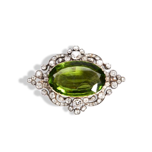 151 - A NINETEENTH CENTURY PERIDOT AND DIAMOND SET BROOCH the oval mixed-cut period within a pierced, scro... 