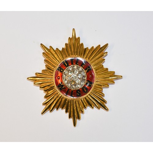210 - A BUTLER AND WILSON CLEAR STONE RED ENAMEL STAR BROOCHin a military style, with BUTLER WILSON writte... 