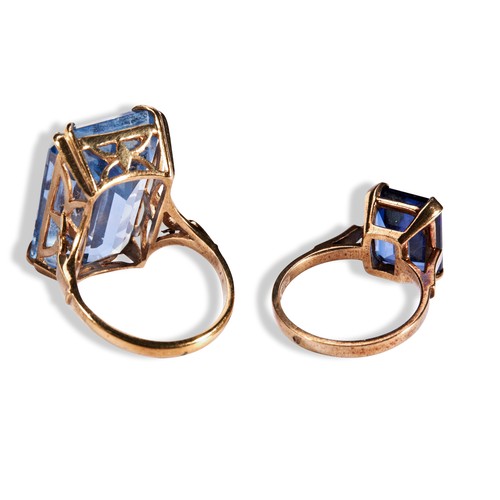 218 - TWO BLUE SYNTHETIC GEMSTONE DRESS RINGS each set with a single rectangular cut synthetic blue gemsto... 