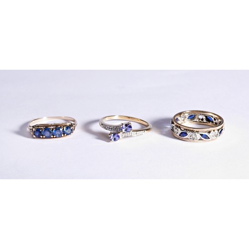 225 - THREE BLUE STONE DRESS RINGSA four stone, four claw set, synthetic sapphire ring.Marked 18kRing size... 