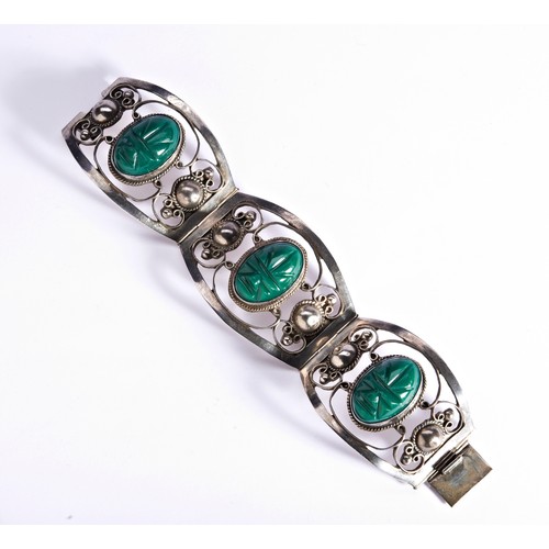 283 - A MEXICAN SILVER CUFF SET WITH GREEN STONE SCARABS.three pierced hinged sections, bezel set with gre... 