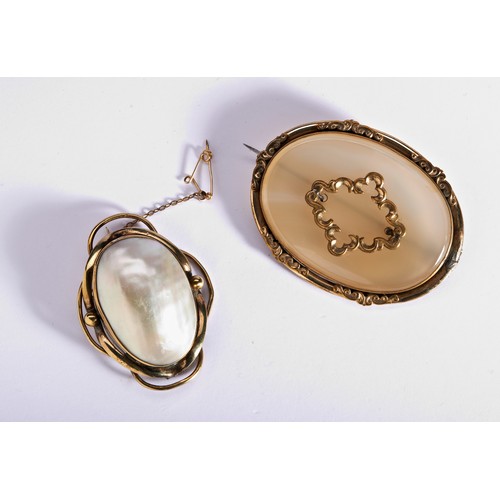 285 - TWO GILT METAL BROOCHESA Victorian gilt metal brooch bezel set with domed mother of pearl, with deco... 