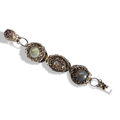 296 - A SILVER BRACELET CIRCA 1972three domed sections each set with each agate, with abstract wire and so... 