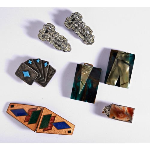 303 - A SET OF COSTUME JEWELLERYIncluding an enamel buckle, a marbled plastic buckle, a pari of paste dres... 