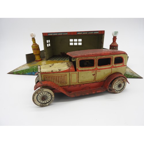 5 - TIPPCO TOY GARAGE WITH MOTOR CAR AND PUMPSTinplate garage with Shell and BP pumps, and model car.... 