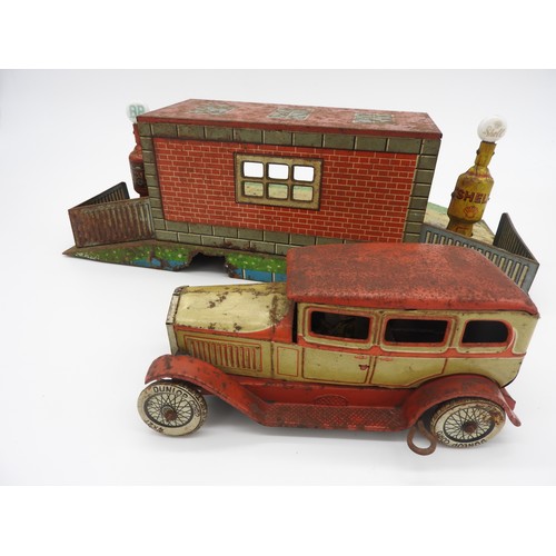 5 - TIPPCO TOY GARAGE WITH MOTOR CAR AND PUMPSTinplate garage with Shell and BP pumps, and model car.... 