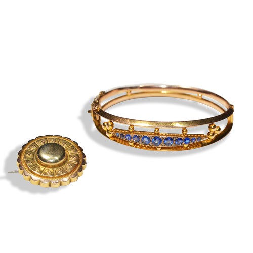 203 - A LATE VICTORIAN BROOCH AND BLUE GEMSTONE BANGLEA shield brooch with granulation detail and hair wor... 