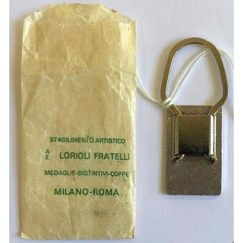 64 - PERIOD FERRARI KEYRING AND PIN BADGESFERRARI KEYRING IN WAXED PAPER PACKET Rare period Ferrari item,... 