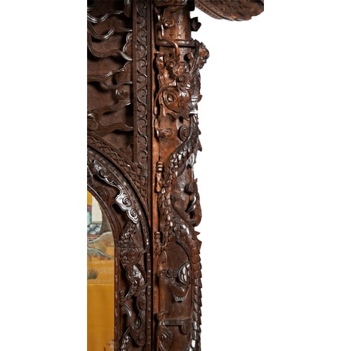 132 - IMPRESSIVE CARVED HARDWOOD 'PAGODA' FORM CABINETQING DYNASTY, 19TH CENTURYthe double-tiered pagoda-f... 