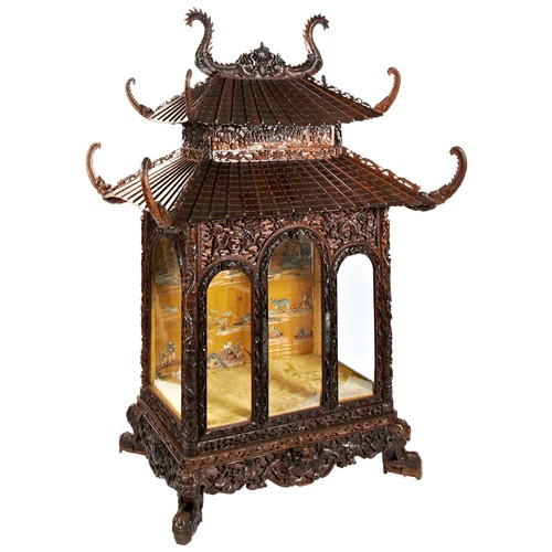 132 - IMPRESSIVE CARVED HARDWOOD 'PAGODA' FORM CABINETQING DYNASTY, 19TH CENTURYthe double-tiered pagoda-f... 