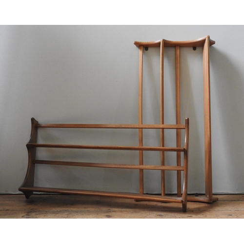 96 - A PAIR OF ERCOL LIGHT ELM MID CENTURY THREE TIER WALL SHELVES, the shelves united by shaped panel si... 