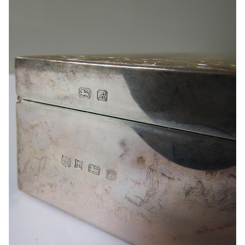 506 - A SILVER ENCASED CIGARETTE BOX, mark of Charles Green, Birmingham, 1975, with chased scroll foliate ... 