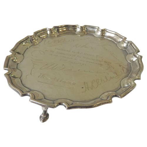 481 - A SMALL SILVER PRESENTATION SALVER, scroll edge decoration, engraved with dedication and signatures,... 