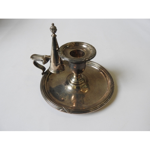 522 - A SILVER CHAMBERSTICK, with fluted cross hatch border decoration, scroll work handle, and a conical ... 