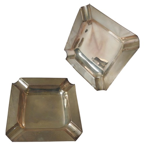 463 - A PAIR OF SQUARE SILVER TRAYS, recessed corners and centre, engine turned border pattern, mark of S ... 