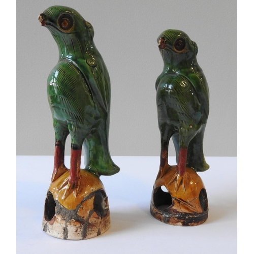 319 - A PAIR OF 19TH CENTURY CHINESE SANCAI GLAZED PARROT FIGURES, perched atop domed bases, 19.5 cm high