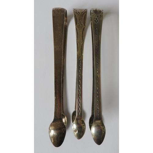 480 - THREE PAIRS OF GEORGIAN SILVER SUGAR TONGS, including:two bright cut decorated pairs of tongs, one p... 