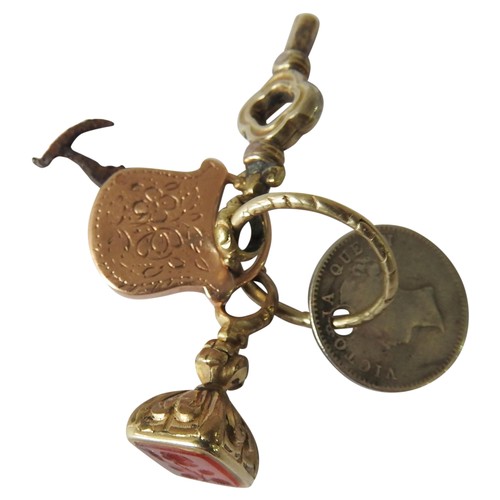 450 - A 19TH CENTURY GOLD CASED CARNELIAN FOB, GOLD CASED MINIATURE BUTTON HOOK, GOLD CASED WATCH KEY AND ... 