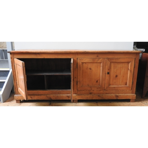 59 - A LARGE 19TH CENTURY CONTINENTAL PINE FOUR DOOR DRESSER BASE, simplistic form with four panelled doo... 