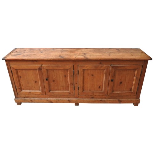 59 - A LARGE 19TH CENTURY CONTINENTAL PINE FOUR DOOR DRESSER BASE, simplistic form with four panelled doo... 